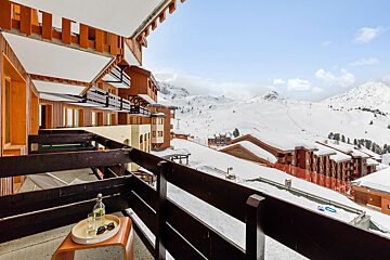 A balcony with a view of snow covered mountains