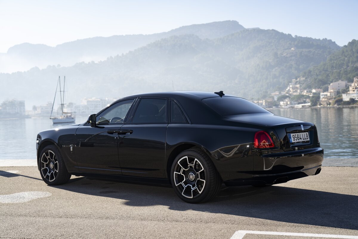 A black car with a license plate that says 994llb