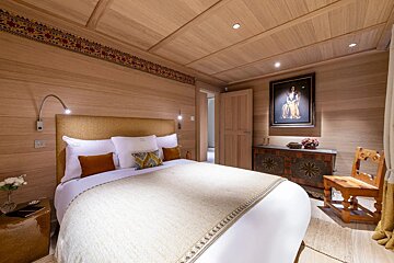 A bedroom with a bed and a picture on the wall