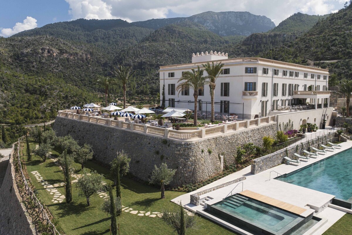 A large white building with a swimming pool in front of it