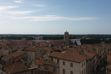 An aerial view of a city with a clock tower in the distance