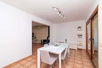 A dining room with a white table and chairs