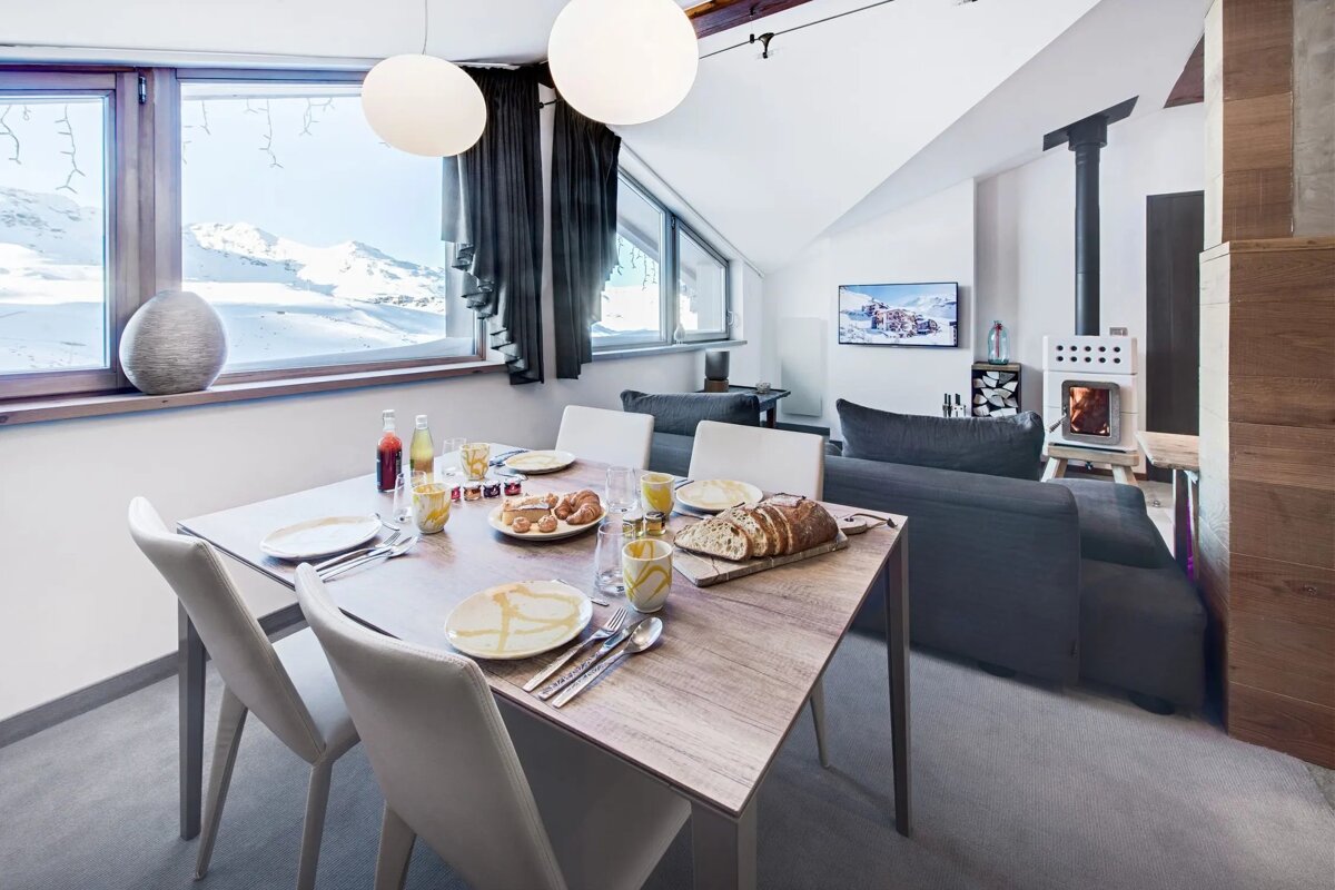 A dining room table with a loaf of bread on it