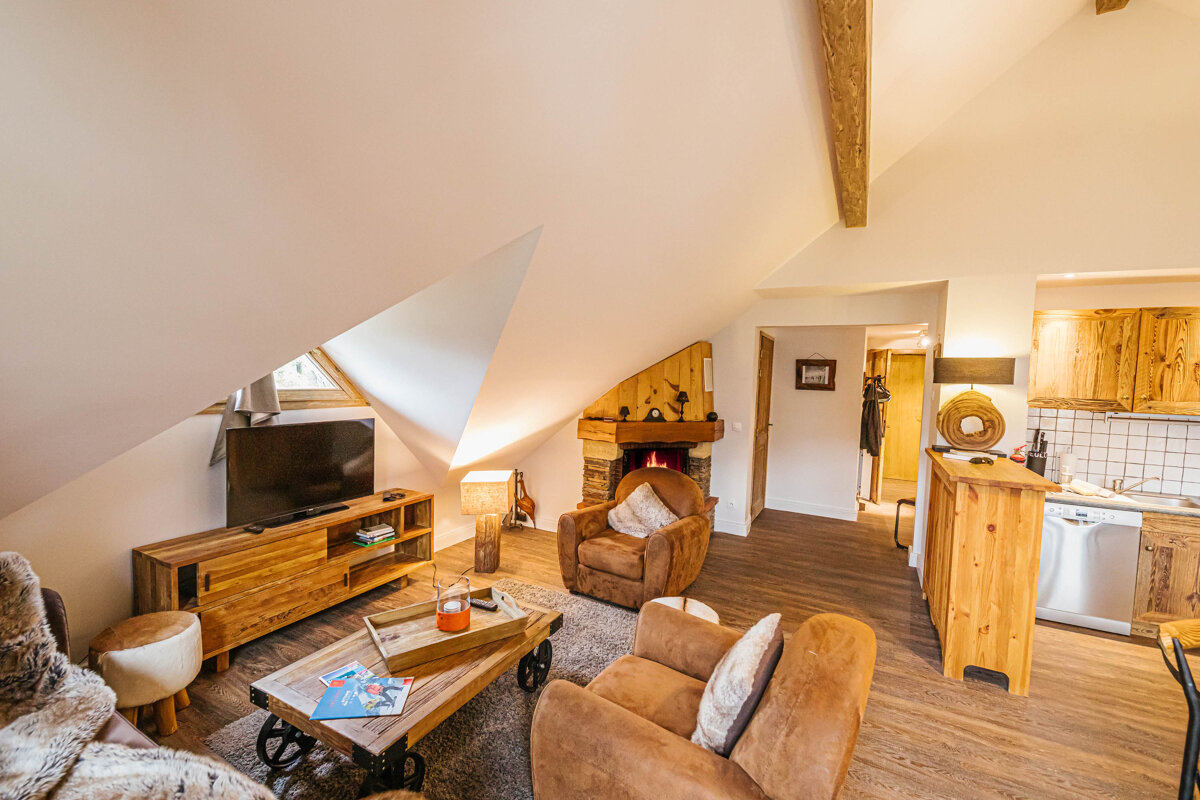 A living room with a fireplace and a flat screen tv