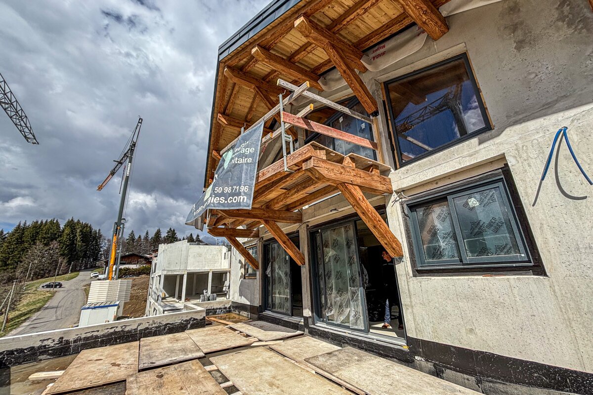 A building under construction with a sign on the side that says 