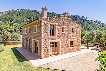 A stone house with a mountain in the background