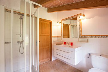 A bathroom with a toilet a sink and a mirror
