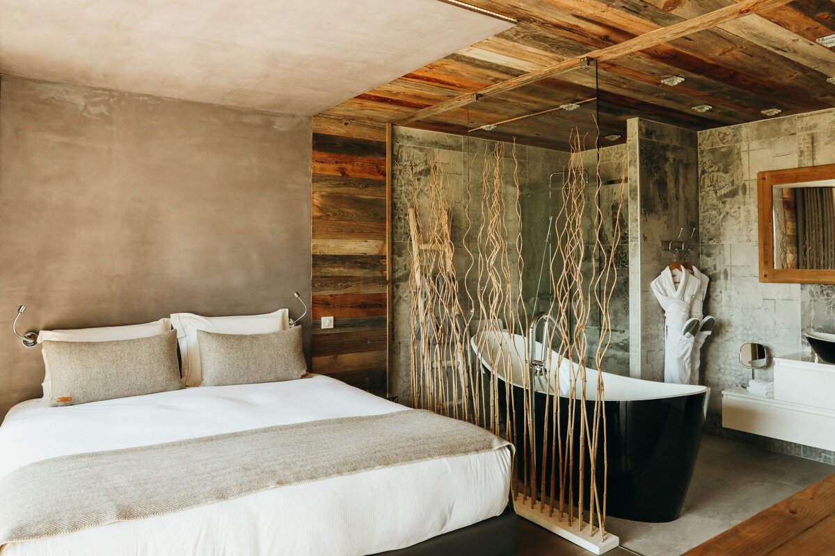 A hotel room with a bed and a bathtub
