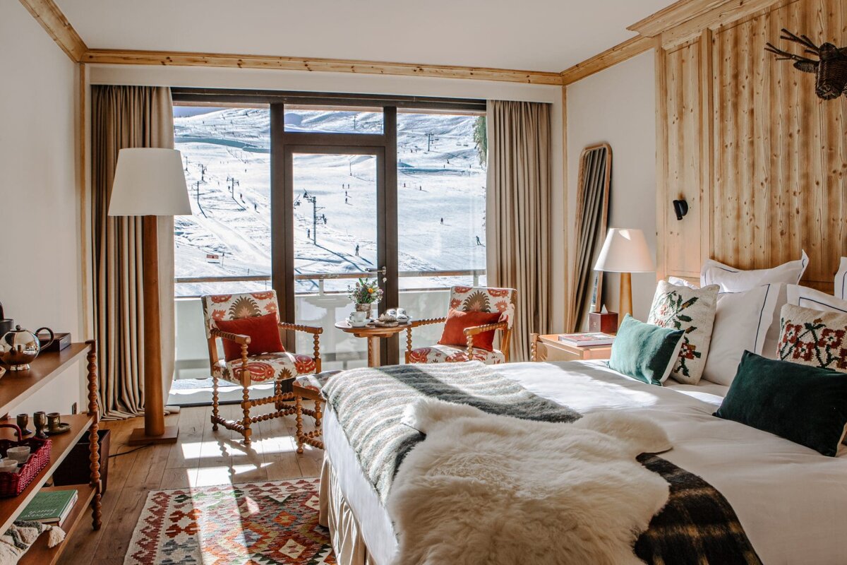 A bedroom with a view of a ski slope