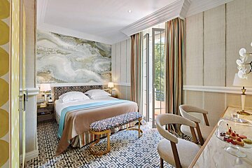 A hotel room with a bed and a desk