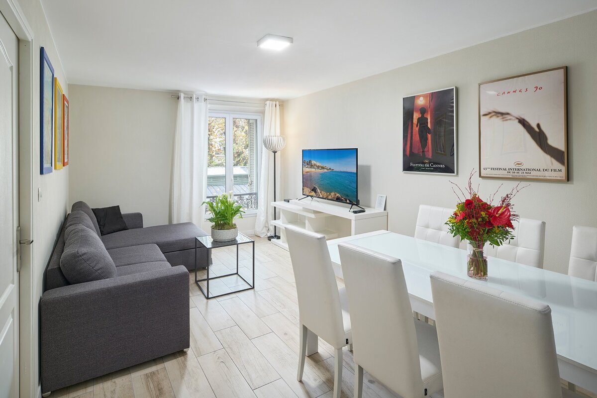 A living room with a couch and a dining table