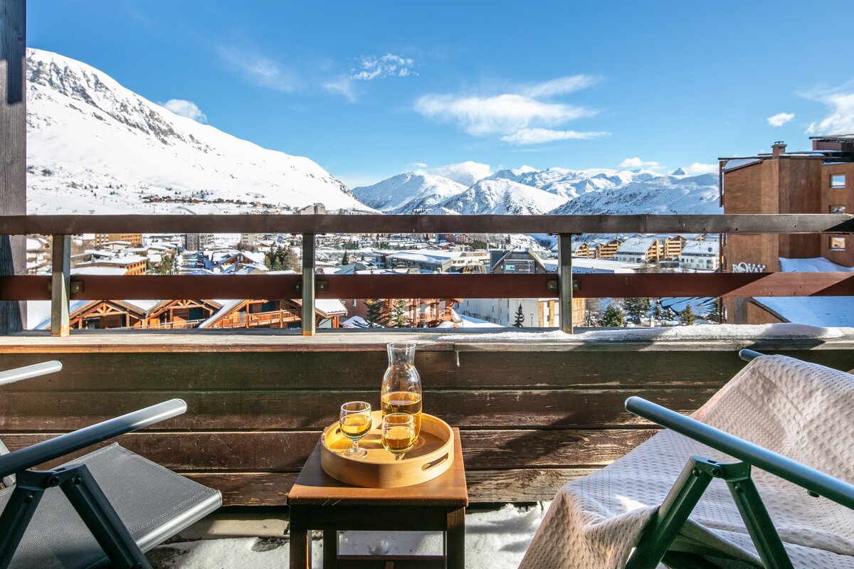 A balcony with a view of a snowy mountain range
