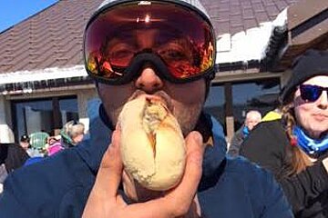 a man eating a steak sandwich