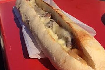 a sandwich with steak and cheese