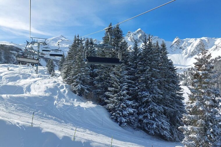 View from the chair lift in Courchevel on a sunny snow day