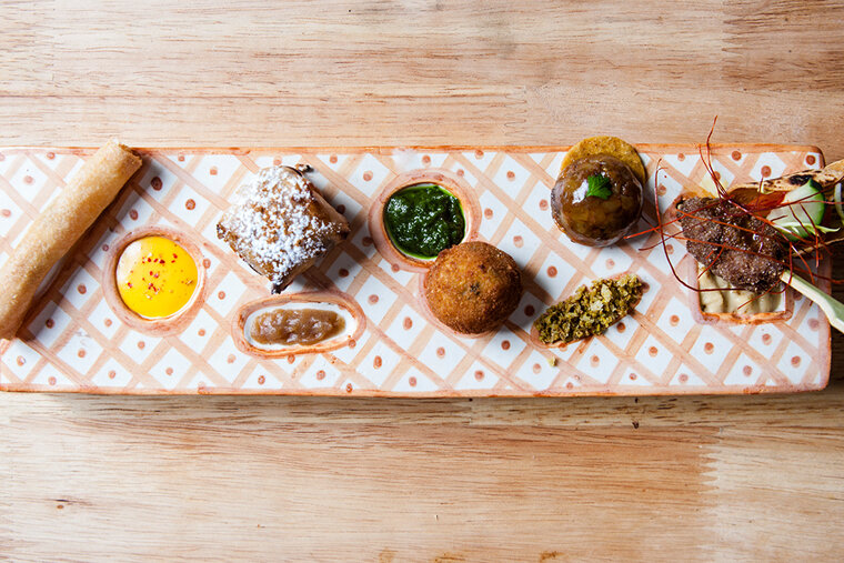 A wooden table with a plate of food on it