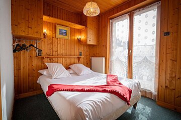 A bedroom with a bed and a picture on the wall