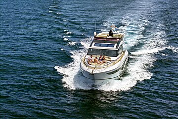 A group of people are on a boat in the ocean