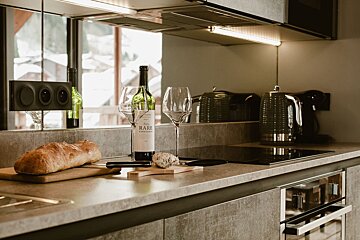 A modern kitchen counter with a bottle of 