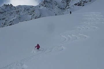 a skier in a pink jacket