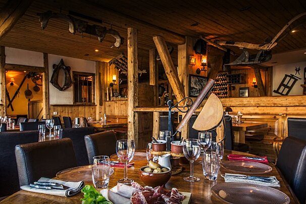 A restaurant with wooden tables and chairs and a sign that says ' a ' on it