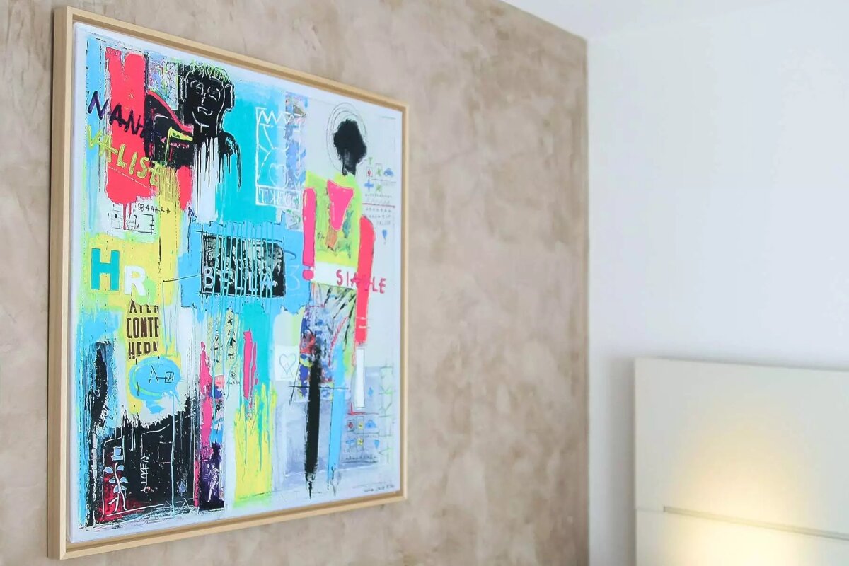 A framed painting on a wall with the word hr on it