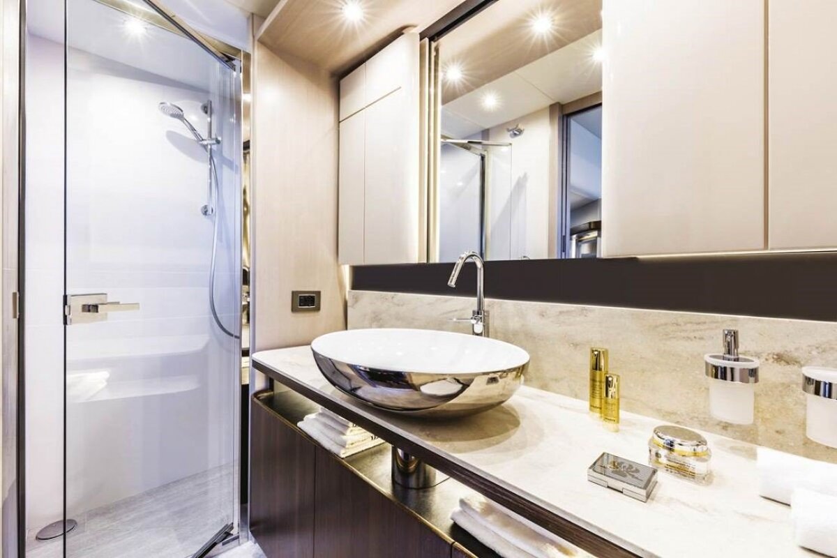 A bathroom with a sink a mirror and a shower