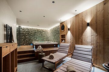 A room with a hot tub and a clock on the wall