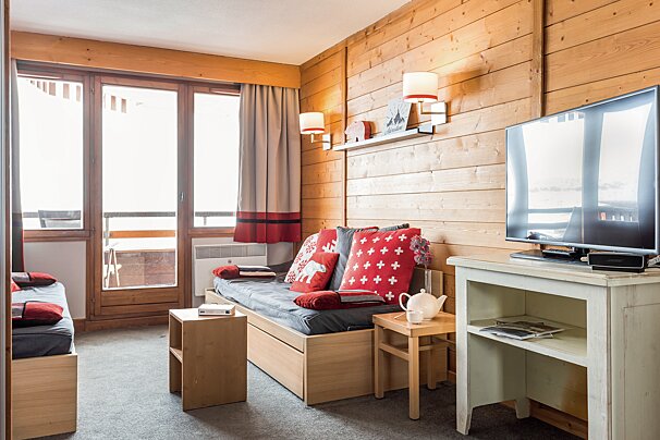 A living room with a couch and a flat screen tv