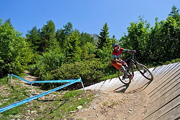 a female mountain biker on a wall ride