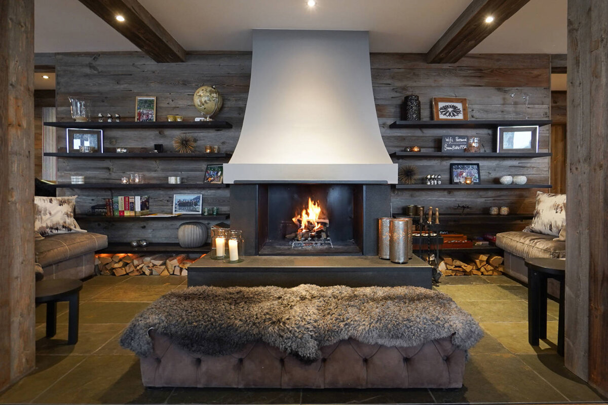 A living room with a fireplace and a rug on the floor