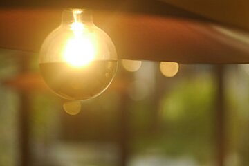 A light bulb with the sun shining through it