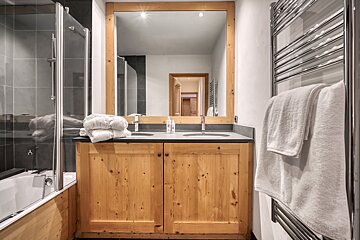 A bathroom with two sinks and a large mirror