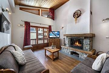 A living room with a fireplace and a flat screen tv