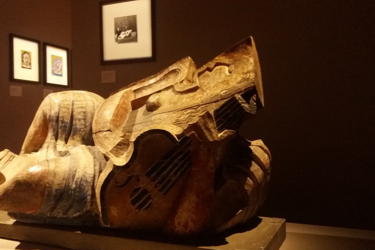 a wooden sculpture in a museum