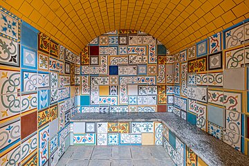 A room with lots of colorful tiles including one that has the letter g on it