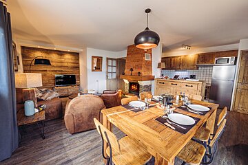 A living room with a wooden table and chairs
