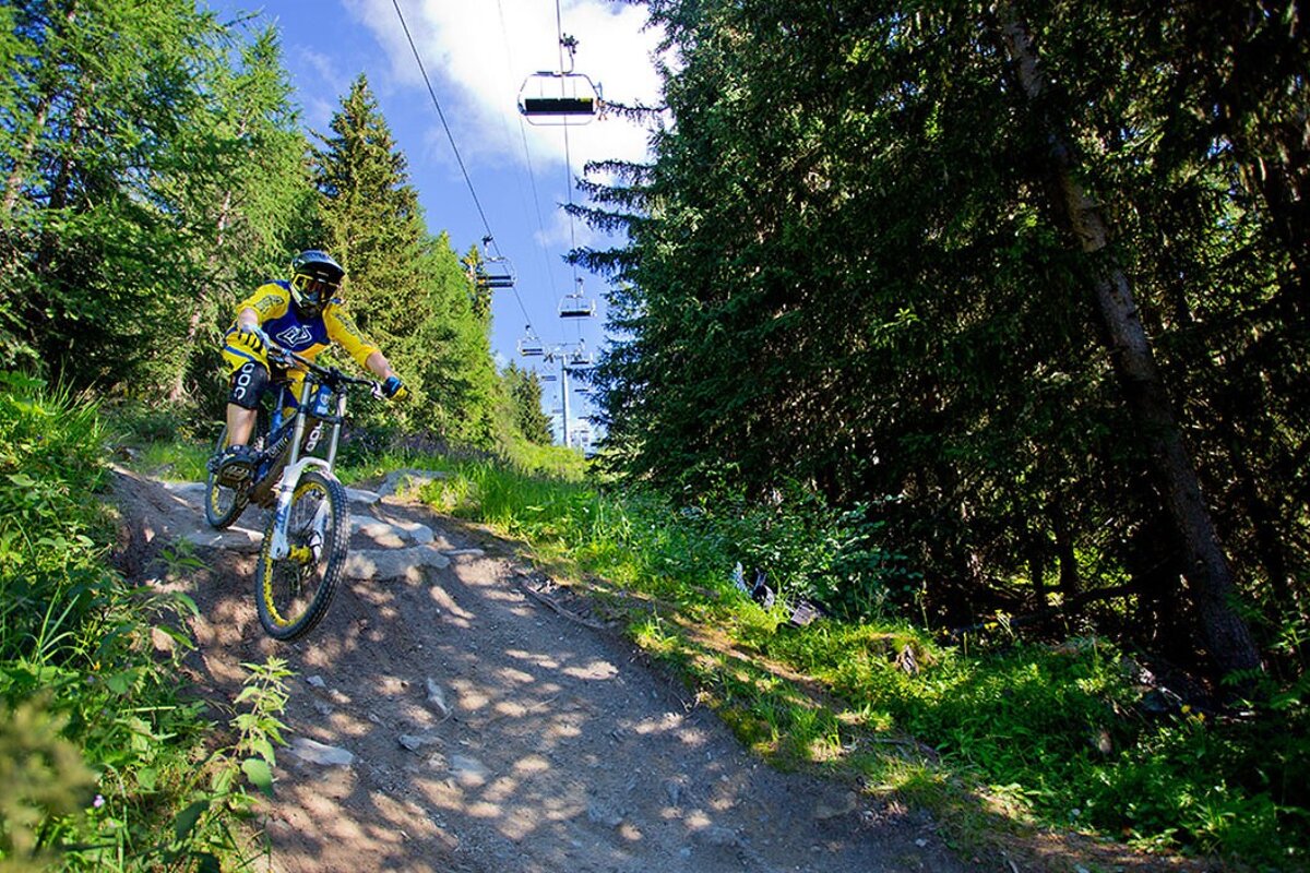 a mountain biker riding over a steep drop