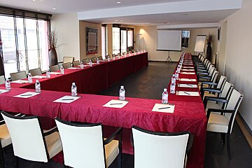 A conference room with a long table and chairs