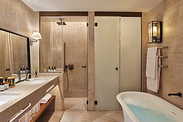 A bathroom with two sinks and a bathtub