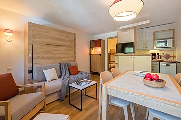 A living room with a couch and a table