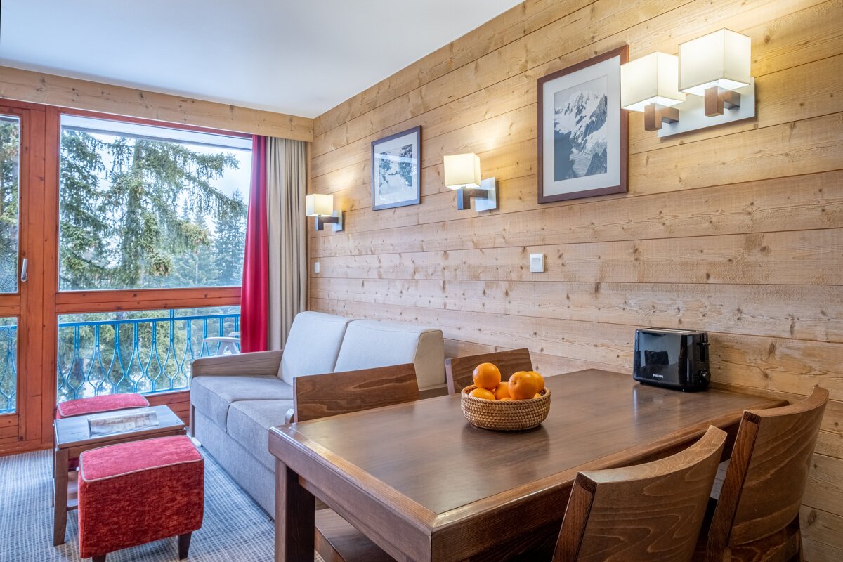 A living room with a couch a table and a toaster