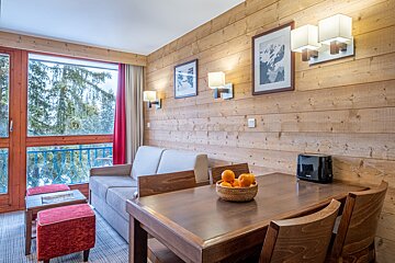 A living room with a couch a table and a toaster