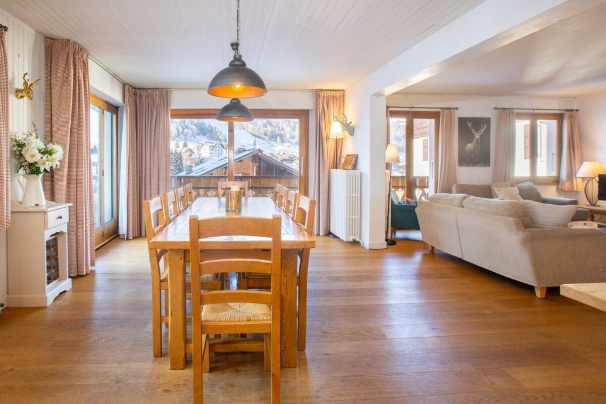 A living room with a dining table and chairs