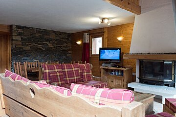 A living room with a fireplace and a flat screen tv