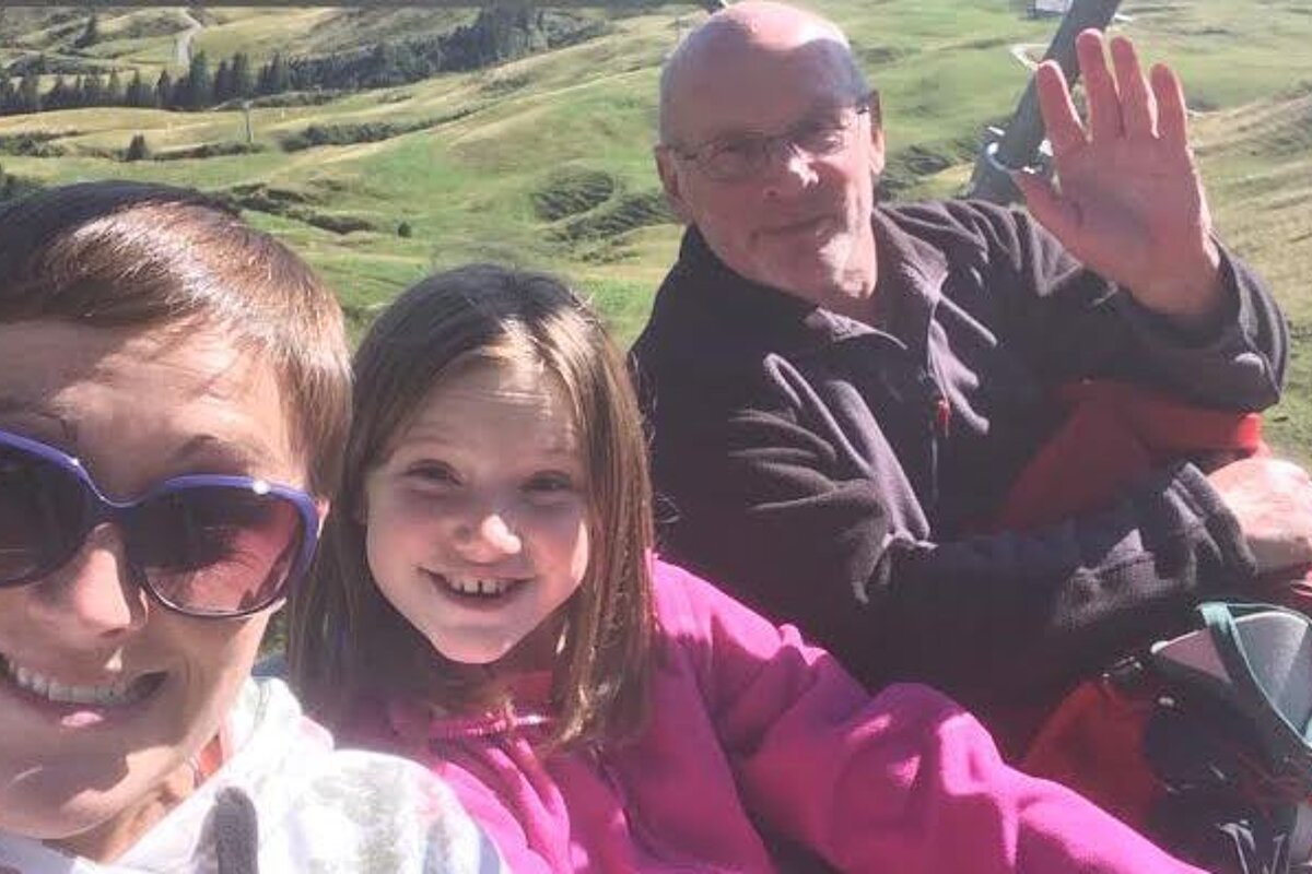 three people on a chair lift