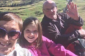three people on a chair lift