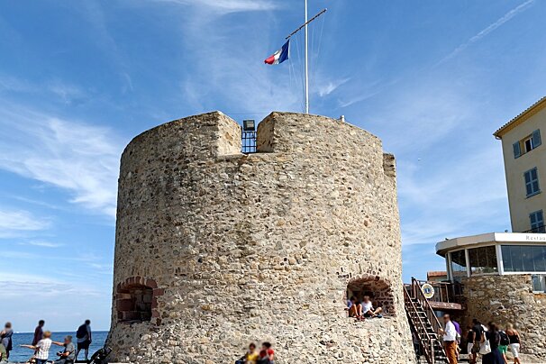 A stone tower with a sign that says