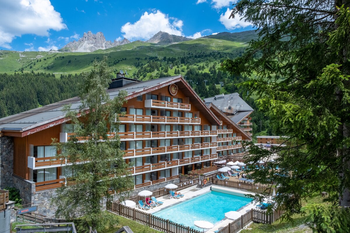 A large building with a swimming pool in front of it