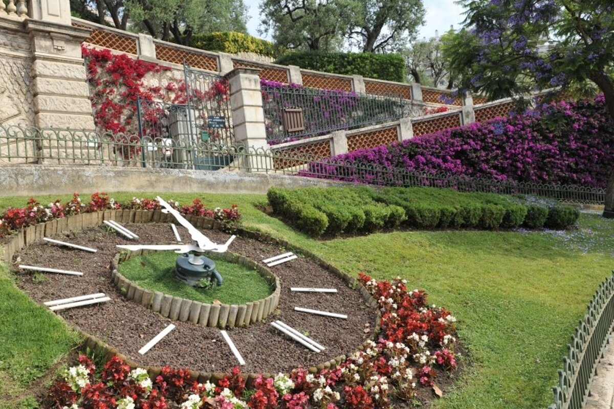 a garden clock & park entrance in monaco